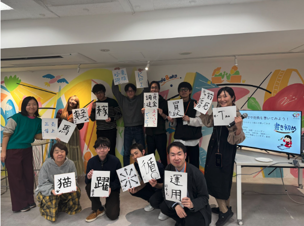 書き初めを手に笑顔の参加者たち